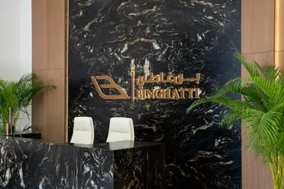 a lobby with two chairs and a sign on a wall at Fully Equipped Studio with Kitchen and Free Wi-Fi in Dubai