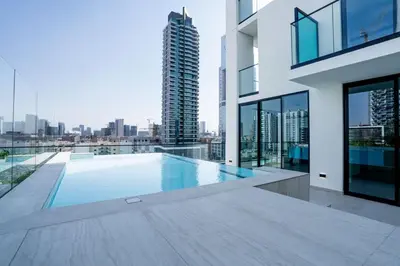 a swimming pool on the roof of a building at Fully Equipped Studio with Kitchen and Free Wi-Fi in Dubai