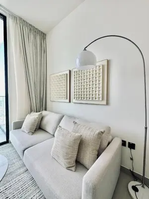a white living room with a couch and a lamp at Cloud Level 1BR Calm with Parking Pool & Gym in Dubai