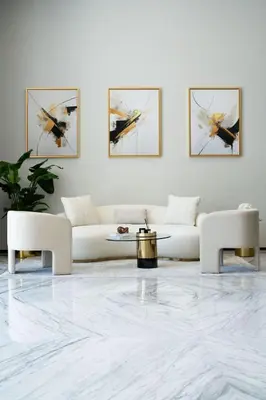 a living room with a white couch and a table at Chic 1BR with free Pool & Gym - Near Mall of Emirates in Dubai