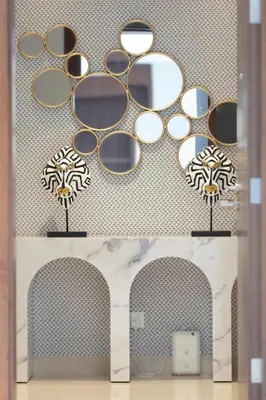 a bathroom with a bunch of mirrors on a wall at Boulevard Point 3BR plus Maid Direct Access to DXB Mall in Dubai