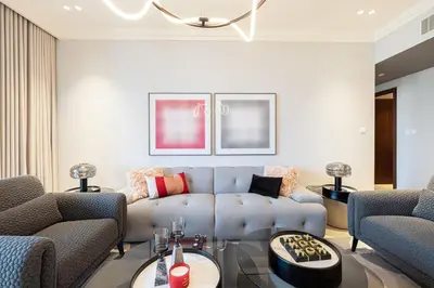 a living room with a couch and two chairs at Boulevard Point 3BR plus Maid Direct Access to DXB Mall in Dubai