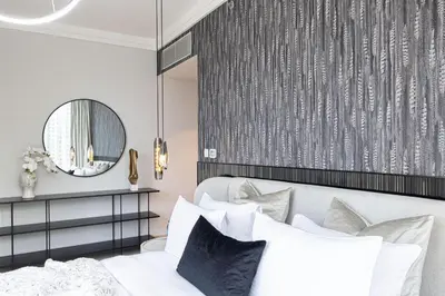 a bedroom with a bed and a mirror at Boulevard Point 3BR plus Maid Direct Access to DXB Mall in Dubai