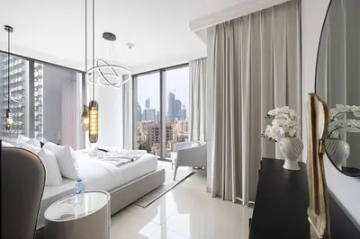 a hotel room with a bed and a large window at Boulevard Point 3BR plus Maid Direct Access to DXB Mall in Dubai