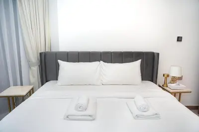 a bed with two white towels on top of it at Live the Opulenco Experience! 2BR Urban Oasis by Missoni, Business Bay in Dubai