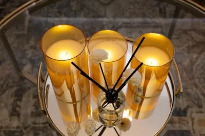 a group of candles in vases on a glass table at Live the Opulenco Experience! 2BR Urban Oasis by Missoni, Business Bay in Dubai