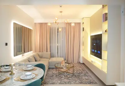 a living room with a couch and a table at Live the Opulenco Experience! 2BR Urban Oasis by Missoni, Business Bay in Dubai