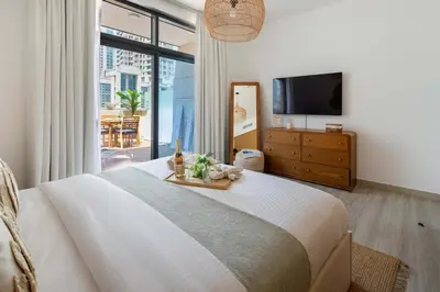 a bedroom with a large bed and a television at Frank Porter - Claren Tower 2, Downtown in Dubai
