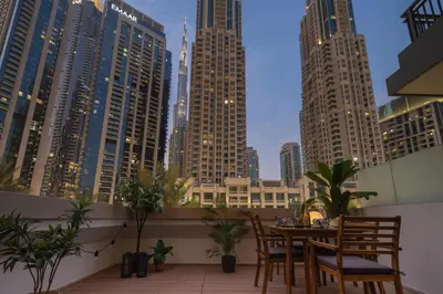 a balcony with a table and chairs and a city skyline at Frank Porter - Claren Tower 2, Downtown in Dubai