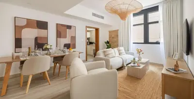 a living room with a table and a dining room at Frank Porter - Claren Tower 2, Downtown in Dubai