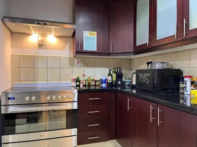 a kitchen with a stove and a microwave at Simbad Friendly Coliving in Dubai