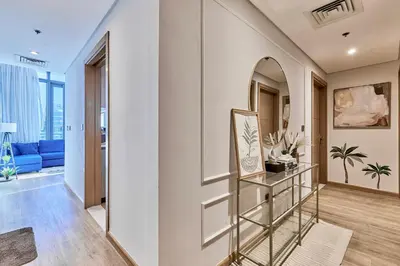 a hallway with a mirror and a blue couch at Private room in BURJ KHALIFA facing 3BR luxury apartment in Downtown Near Dubai Mall Metro in Dubai