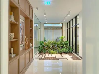 a hallway with plants in the middle of a building at FIRST CLASS 1BR Luxe Living with a View in Dubai