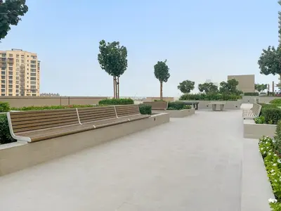 a park with benches and trees in a city at FIRST CLASS 1BR Luxe Living with a View in Dubai