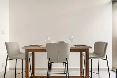 a dining room table with three chairs and a table at FIRST CLASS 1BR Luxe Living with a View in Dubai