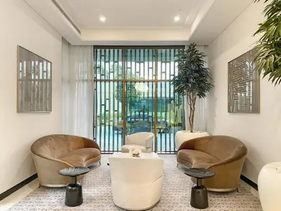 a living room with two chairs and a table at FIRST CLASS 1BR Luxe Living with a View in Dubai