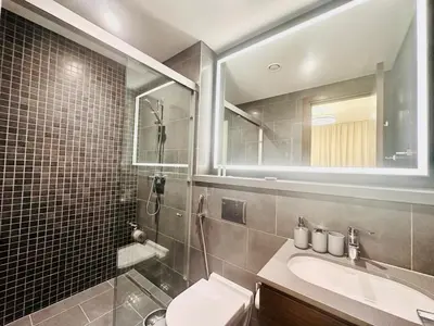 a bathroom with a sink and a toilet and a mirror at Modern 02 Bedroom in Sobha Crest B in Dubai