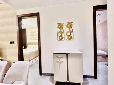 a white room with a mirror and a table at Modern 02 Bedroom in Sobha Crest B in Dubai