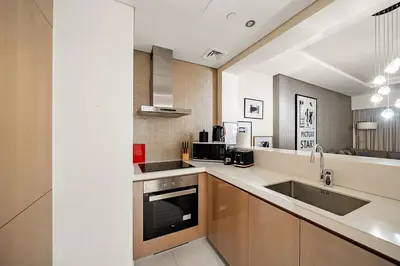 a kitchen with a sink and a counter top at FIRST CLASS 2BR Mesmerizing Burj Khalifa View in Dubai