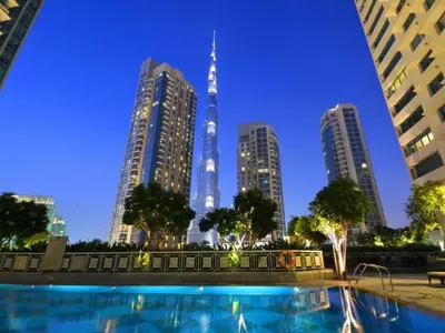 a pool in front of a city skyline with tall buildings at 2BR Downtown Gem with Burj Khalifa and Fountain Views in Dubai
