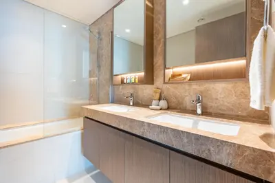 a bathroom with two sinks and a tub at Fantastic 2BR apartment Palm, Sea and Sunset Views in Dubai