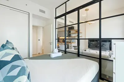 a bedroom with a white bed and a large window at 1BR Little Haven in Collective T1, Dubai Hills in Dubai