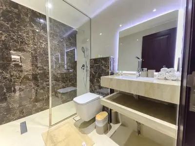 a bathroom with a sink and a toilet and a shower at Central & Luxurious 2BR- Burj Khalifa & Dubai Mall in Dubai