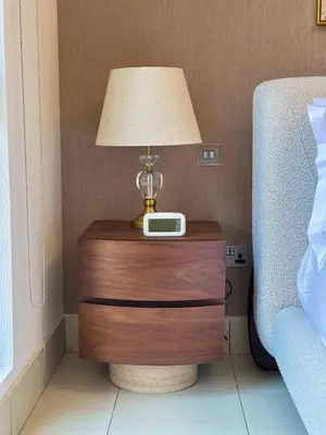 a table with a lamp and a clock on it at Central & Luxurious 2BR- Burj Khalifa & Dubai Mall in Dubai