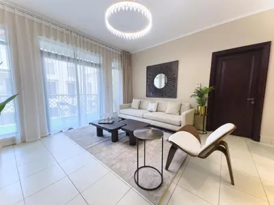 a living room with a couch and a table and chairs at Central & Luxurious 2BR- Burj Khalifa & Dubai Mall in Dubai