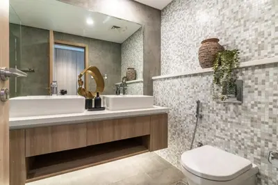 a bathroom with two sinks and a toilet and a mirror at The Smart Concierge - Stella Maris in Dubai