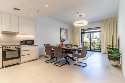 a kitchen and dining room with a table and chairs at The Smart Concierge - Jadeel 1 MJL in Dubai