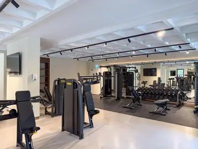 a gym with rows of treadmills and weights at The Smart Concierge - Jadeel 1 MJL in Dubai