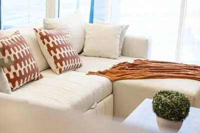 a white couch with pillows on it in a living room at Elegant 3BR Lux Stay in the Heart of Dubai Marina in Dubai