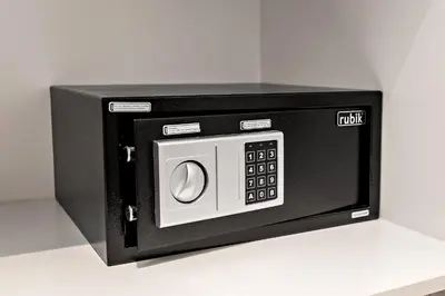 a black microwave oven on a white counter at Stylish 1BR Apartment at Meera Tower in Dubai