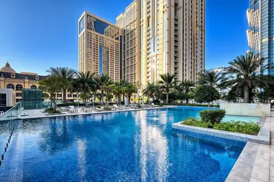 a large swimming pool in front of some buildings at Stylish 1BR Apartment at Meera Tower in Dubai