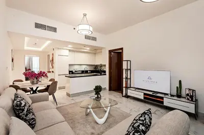 a living room with a couch and a tv at Stylish 1BR Apartment at Meera Tower in Dubai