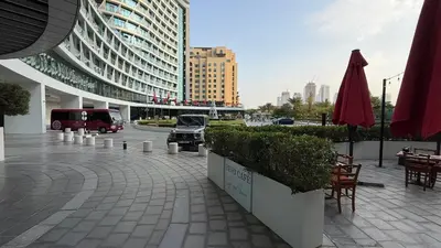 a parking lot with a car parked in a building at Beachfront Bliss, Seven Palm Studio Apartment in Dubai