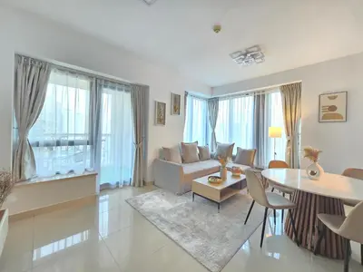 a living room with a couch and a table at Versatile 1BR with Burj Khalifa View in Dubai
