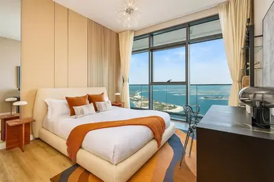 a bedroom with a bed and a large window at Serene Ocean Views, 2BR Emaar Beachfront in Dubai