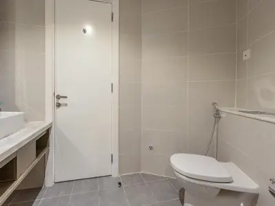 a white bathroom with a toilet and a sink at Luxury Studio | Near Dubai Mall | Lake View in Dubai