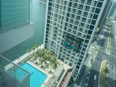 an aerial view of a large building with a swimming pool at Luxury Studio | Near Dubai Mall | Lake View in Dubai