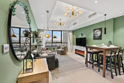 a living room with a couch and a table at Modern Apt just Steps to Metro & Lake with Pool andParking in Dubai