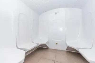 a bathroom with white urinals in a room at Modern Apt just Steps to Metro & Lake with Pool andParking in Dubai