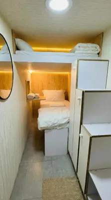 a small room with two bunk beds and a mirror at Oval Tower Retreat, Business Bay in Dubai