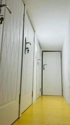 an empty hallway with white doors and a wooden floor at Oval Tower Retreat, Business Bay in Dubai