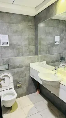 a bathroom with a toilet and a sink at Oval Tower Retreat, Business Bay in Dubai