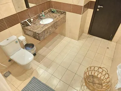 an overhead view of a bathroom with a toilet and a sink at Modern Studio Near Dubai World Trade Centre in Dubai