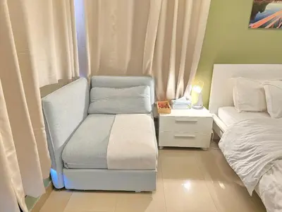 a small room with a bed and a chair at Charming Studio Near World Trade Center & Subway in Dubai