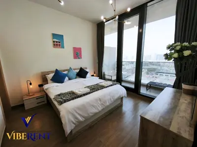a bedroom with a large bed and a large window at 1BHK Pool Sauna 15 Min to Marina in Dubai