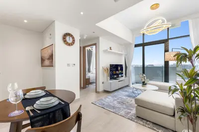 a living room with a table and a couch at Urban Chic Apartments in Dubai